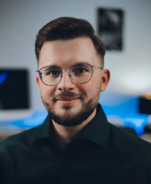 A man wearing glasses and a green shirt.